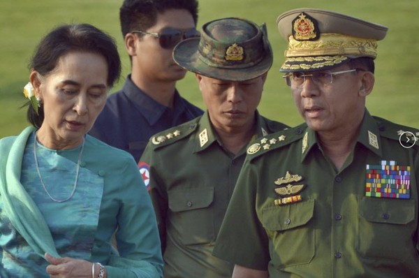 FILE - In this May 6, 2016, file photo, Aung San Suu Kyi, left, Myanmar's foreign minister, walks with senior General Min Aung Hlaing, right, Myanmar military's commander-in-chief, in Naypyitaw, Myanmar. Myanmar military television said Monday, Feb. 1, 2021 that the military was taking control of the country for one year, while reports said many of the country’s senior politicians including Suu Kyi had been detained. (AP Photo/Aung Shine Oo, File) - pics/2021/02/57918_001.jpg